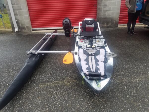 A canoe with a black outrigger