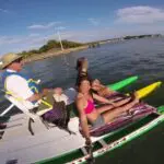 Three people sitting on a boat