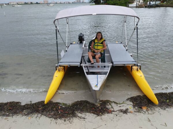 Person on a boat with two-sided outriggers