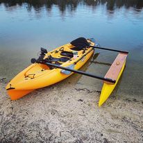 A yellow boat with a one-sided outrigger