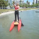 A man standing on a mini pontoon boat