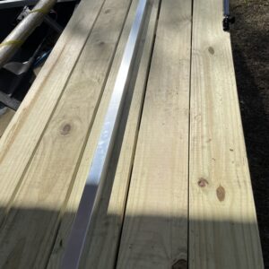 A measuring tool on top of a wood plank