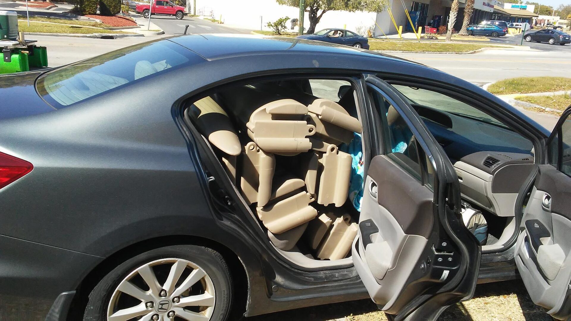 A set of modular kayaks inside a car